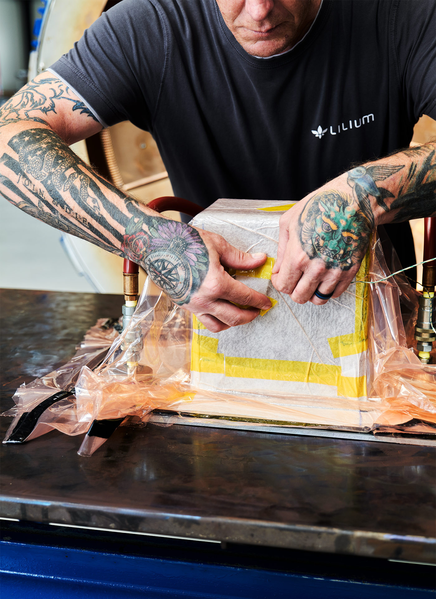 Tatooed hand working on a Jet Battery during systems test